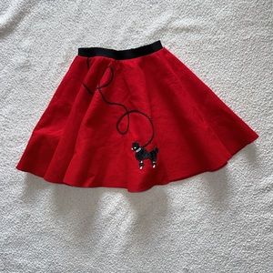 Skirt in size xs. by Hip Hop 50’s shop, red with poodle dog on front, pre-owned